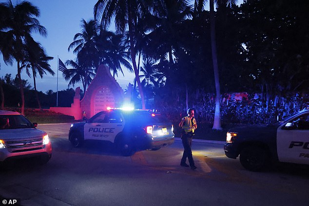 Police direct traffic outside the entrance to former President Donald Trump's Mar-a-Lago estate, Monday, Aug. 8, 2022, in Palm Beach, Florida.  Trump said in a lengthy statement that the FBI was conducting a search of his Mar-a-Lago real estate and claimed agents had broken into a safe.