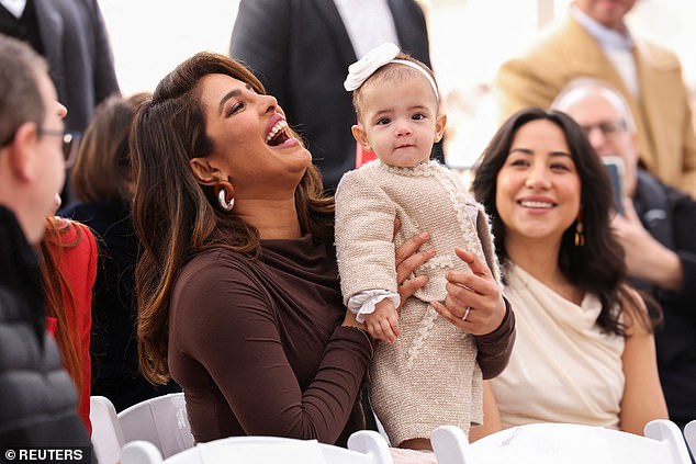 First glance!  Sitting front and center for the historic moment was Nick Jonas's wife, Priyanka Chopra, who held year-old Malti Marie on her lap during the ceremony.