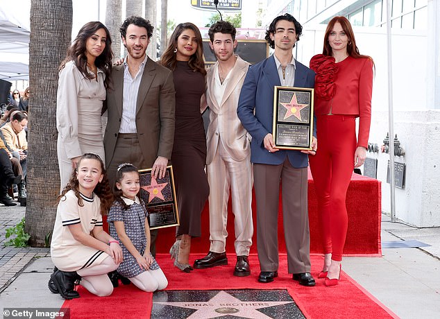 All together!  Kevin Jonas, his wife Danielle, their two daughters Valentina, six, and Alena, eight, posed with Nick, Priyanka, Joe and Sophie Turner.