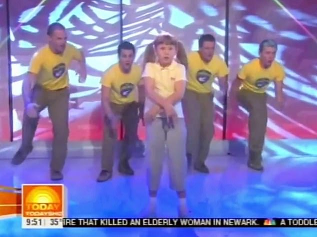 The clip shows nine-year-old Bindi performing her first single 'Trouble In the Jungle' live on stage, flanked by a troupe of adult dancers, known as The Crocmen.