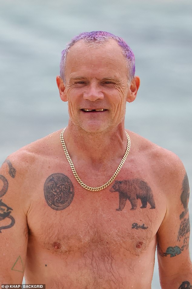 Flea showed off her golden teeth after a refreshing dip in the ocean.