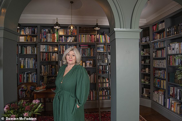 Susan Roe transformed her game room into a library and sitting room, complete with a traditional ladder to reach the highest shelves.