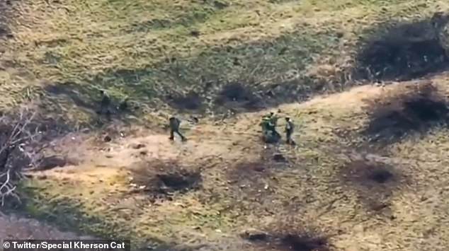 In the video, a group of Russian soldiers can be seen walking through a field with detonated mines.