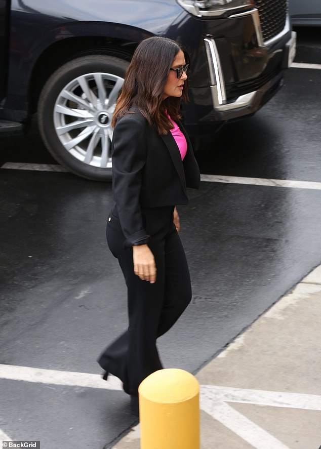 Stylish: Salma added a touch of intrigue to her traditional outfit with a cropped black blazer, which she wore with the sleeve cuffs casually turned up