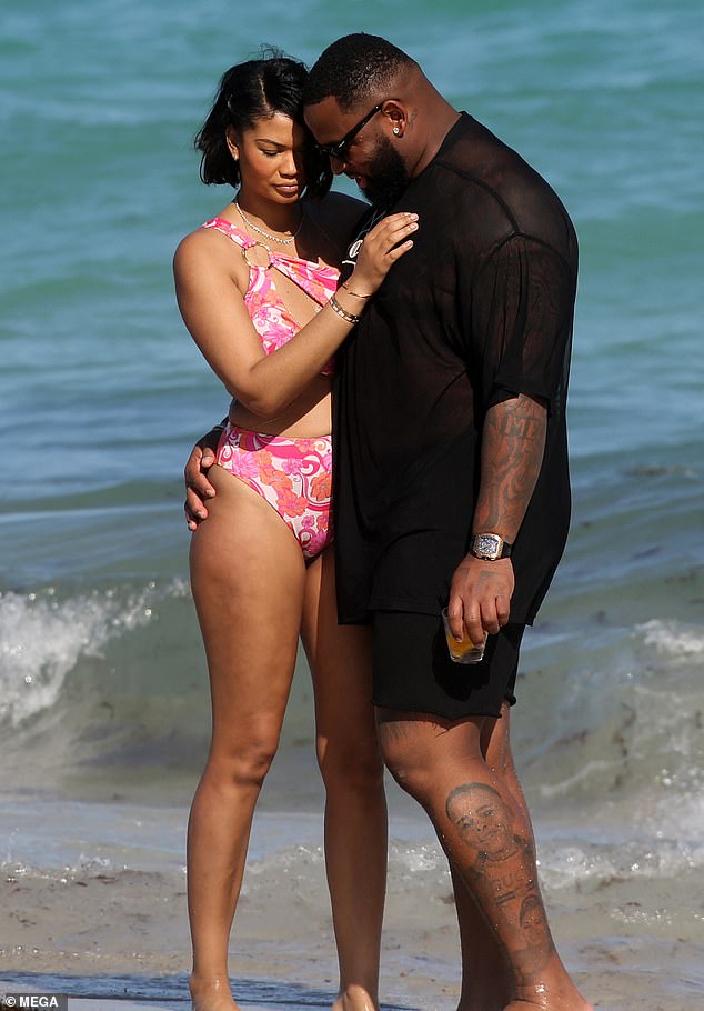 In love: The supermodel and her New England Patriots player looked smitten as they hugged by the ocean