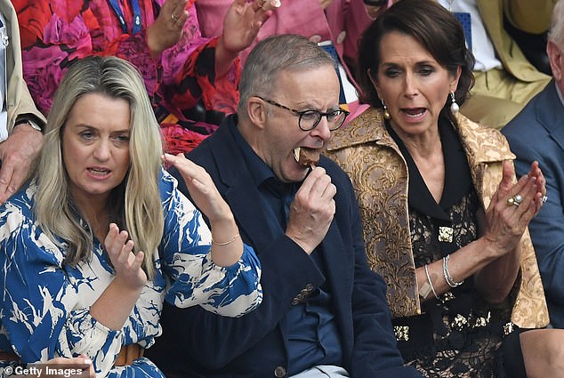 Prime Minister Anthony Albanese mocking an ice cream at tennis with his partner Jodie Haydon and Virgin CEO Jayne Hrdlicka in the men's singles final on Sunday.