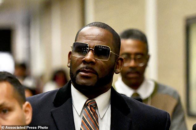 Kelly is seen in May 2019 leaving the Daley Center in Chicago after a hearing in her child support case.  The 56-year-old is currently serving a 30-year sentence after a New York court found him guilty of sexually abusing girls.