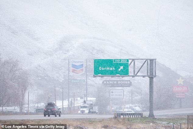 An SUV was seen driving on I-5 in Gorman as snow continued to fall Monday