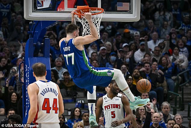 Doncic dunks the ball as Detroit Pistons guard Alec Burks (5) and forward Bojan Bogdanovic