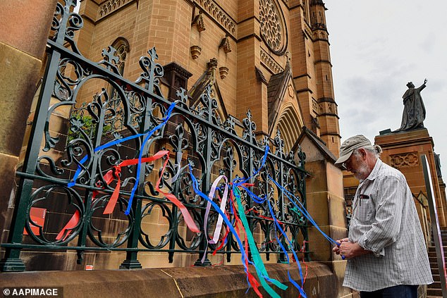 Survivors of child sexual abuse began tying colored ribbons (above) to the door of St. Mary's in hopes of forcing the church to recognize Pell's controversial legacy.