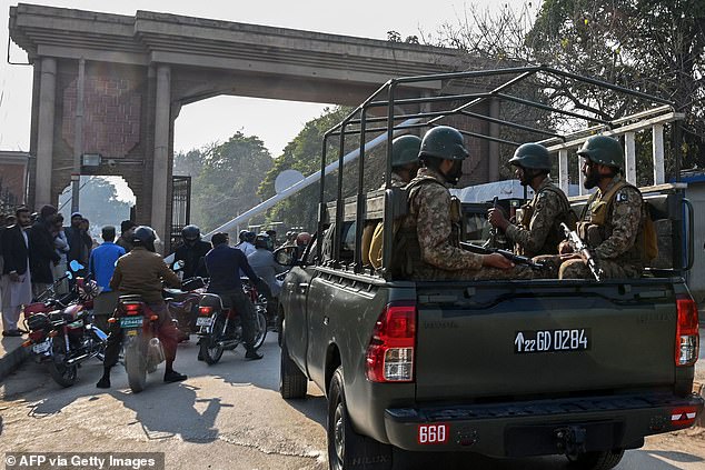 Pictured: Pakistan's army soldiers patrol outside the police headquarters a day after a mosque blast in Peshawar on January 31, 2023