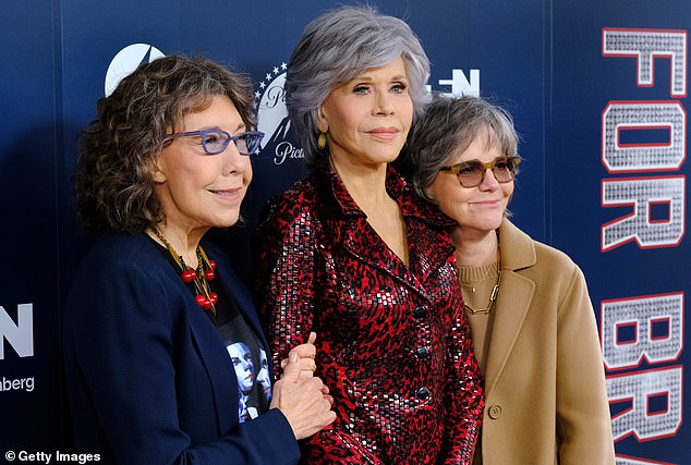 A touch of red: Tomlin, 83, meanwhile, wore a graphic T-shirt under a blue pantsuit, which she paired with a necklace of red cherries