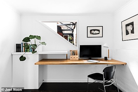 There is a soundproof study space next to the entrance and stairs lead up to a blank canvas mezzanine that overlooks the living room.