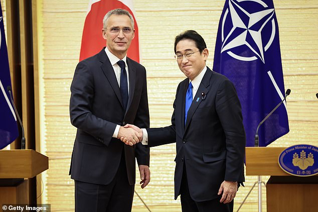 Secretary General Jens Stoltenberg (left) and Japan's Prime Minister Fumio Kishida shake hands after a joint press conference Tuesday in Tokyo, Japan.