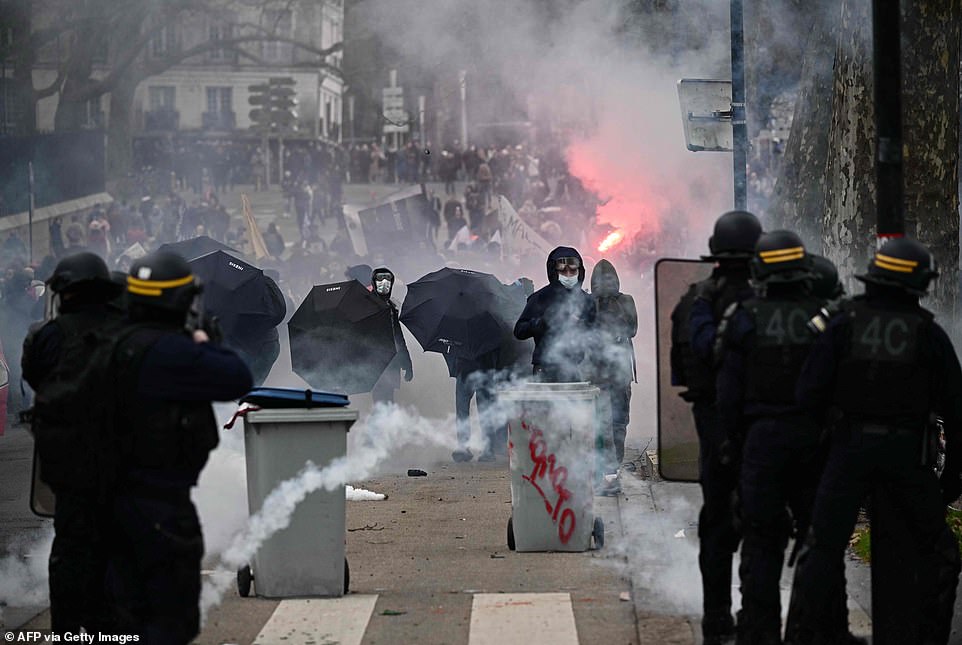 French riot police face protesters who demonstrate on a second day of nationwide strikes and protests over the government's proposed pension reform in Nantes on Tuesday