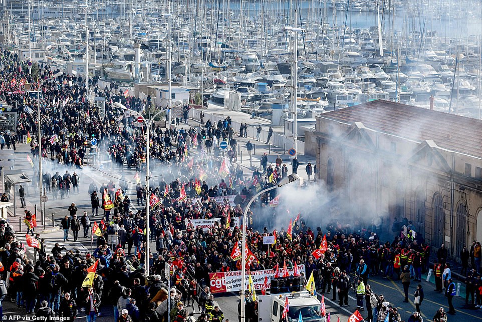 People take part in the demonstration in Marseille on January 31 as part of a nationwide day of strikes and rallies for the second time in a month to protest a planned reform to boost the age of retirement from 62 to 64