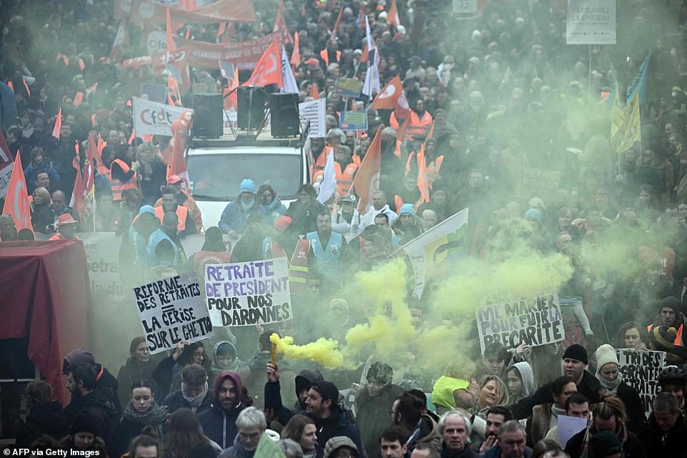 Protesters set off flares as they demonstrate on a second day of nationwide strikes and protests over the government's proposed pension reform, in Nantes on Tuesday