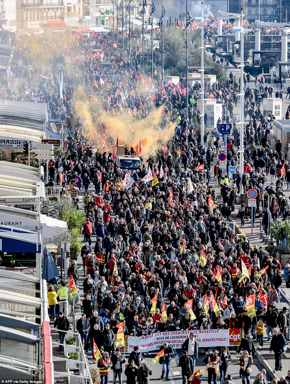 People take part in a demonstration in Marseille on January 31, 2023 as part of a nationwide day of strikes and rallies for the second time in a month to protest a planned reform to boost the age of retirement from 62 to 64