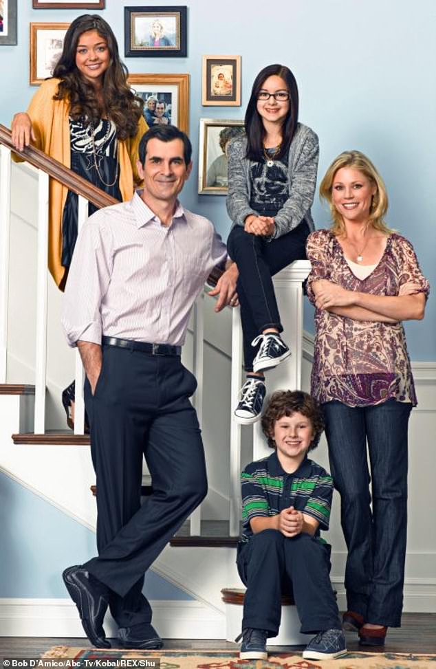 As a child: Winter is seen here in 2009 sitting on the stair railing in Modern Family;  also pictured are Sarah Hyland, Ty Burrell, Julie Bowen and Nolan Gould