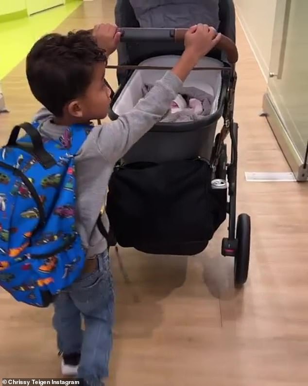 Big brother: He also shared a video of his son pushing his little sister