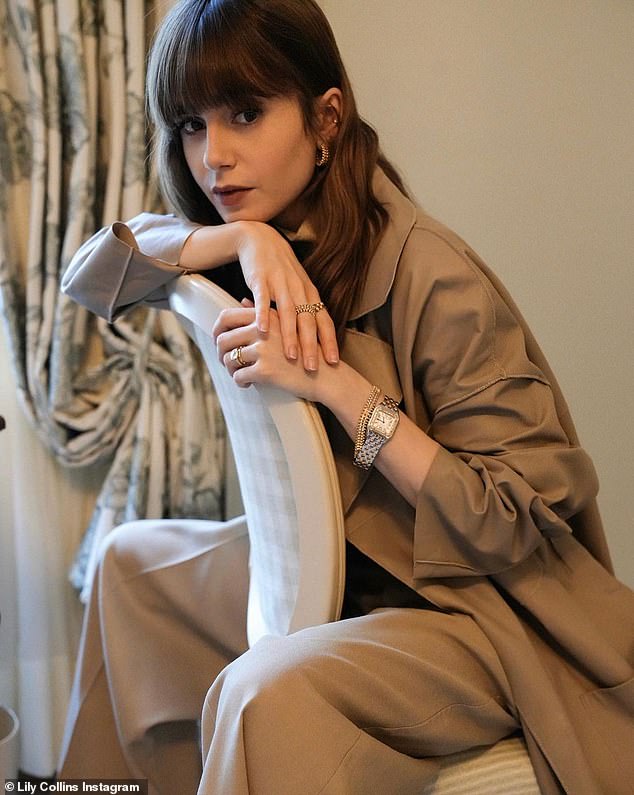 Brown-eyed girl: Lily, 33, straddles a chair while wearing a beige Cartier suit and one of the brand's iconic watches.