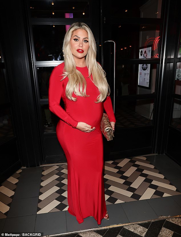 Glowing: The former Celebrity Big Brother star, 36, looked amazing in a skintight red dress as she cradled her tummy