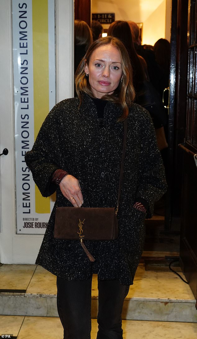 Looking good: She wore a pair of black loafers and carried a dark chocolate brown YSL bag with her