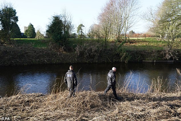 Police search a bank by the River Wyre near where the missing mother-of-two was last seen on Friday morning.