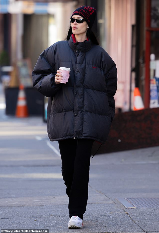 All bundled up: The 21-year-old supermodel braced herself for the wintry temperatures in New York City in a black coat