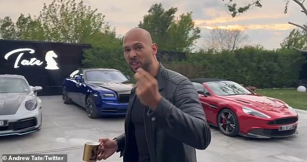 Romanian police have seized 11 luxury cars from notorious misogynist Andrew Tate and his brother Tristan after they were both arrested on traffic charges.  Pictured: Tate appears in a video in front of at least two of the cars that have been seized by investigators (a Rolls-Royce and an Aston Martin)