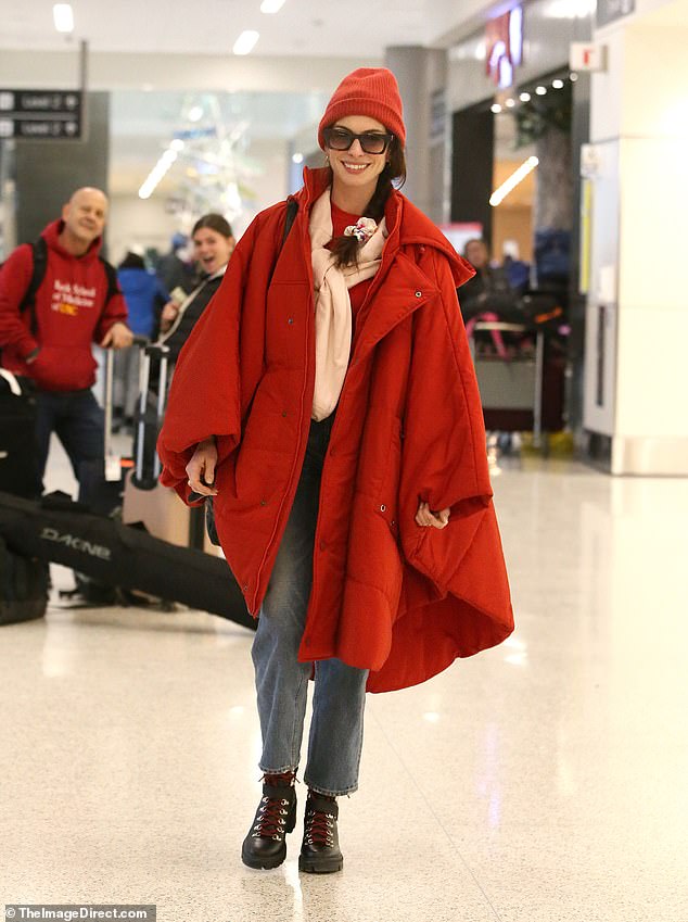 Standing out from the crowd: Anne Hathaway rocked a vibrant all-red outfit as she prepared to leave the Salt Lake City airport after attending the 2023 Sundance Film Festival in Park City, Utah