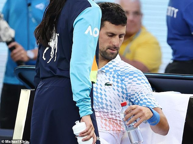 Novak Djokovic is once again the talk of the Australian Open after footage emerged of the fourth seed receiving a message taped to his water bottle from his entourage (pictured, reading the message)