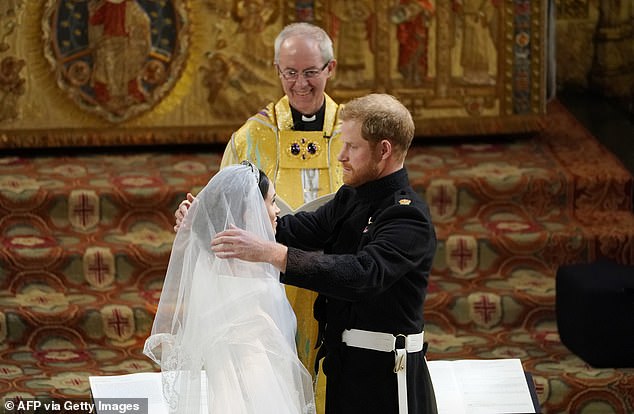 ALL SMILES: Justin Welby (back) at the wedding of Prince Harry (right) and Meghan (left) at St George's Chapel