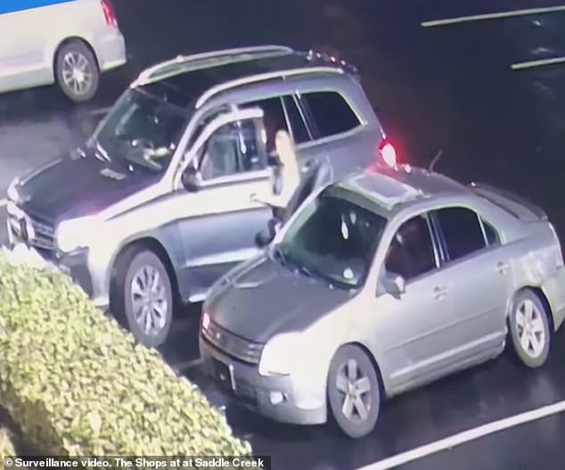 The unidentified woman opens the door of her truck at the ambush