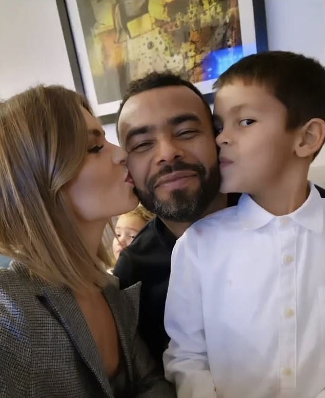 Family: Ashley Cole got a kiss on each cheek from her fiancée Sharon Canu and their son Jaxon in a rare family snap as they ringed in the New Year