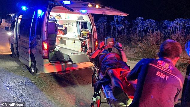 Australian expat Graeme Foster is shown on a stretcher, about to be put into an ambulance.