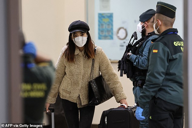 A passenger on a flight from Beijing leaves the terminal after landing at the Adolfo Suárez Madrid-Barajas de Barajas airport, on the outskirts of Madrid, on December 31, 2022.