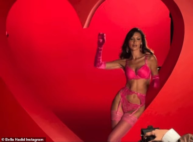 Pretty in pink: Bella Hadid, 26, revealed her chiseled figure in hot pink lingerie on Monday in behind-the-scenes clips of herself filming a Valentine's Day-themed campaign for Victoria's Secret.