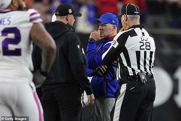 Coaches Sean McDermott and Zac Taylor speak after a break in play on Monday night.