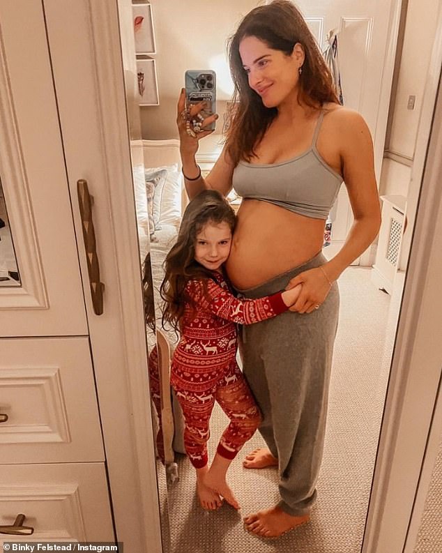 Baby joy: Binky Felstead showed off her blossoming baby bump on Saturday as she revealed she was hoping to feel the 'kicks'