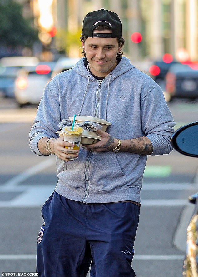 Happy: Brooklyn Beckham appeared to be in high spirits on Friday as he stepped out for lunch and a smoothie at Erewhon Market in Los Angeles