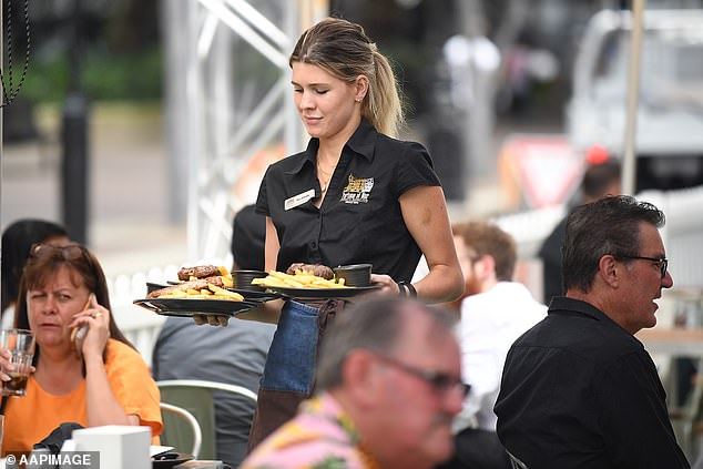 Business and banking elites are calling on workers to take an even harsher cut in real wages after inflation spiked to a new 32-year high (Sydney waitress pictured)