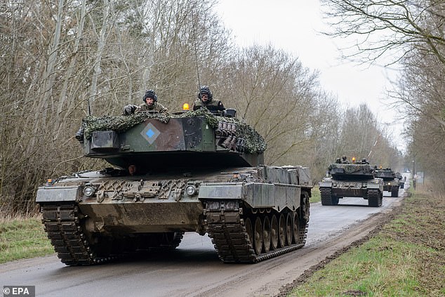 Polish soldiers are shown in German-made Leopard 2 tanks that Olaf Scholz is blocking from being delivered to Ukraine.