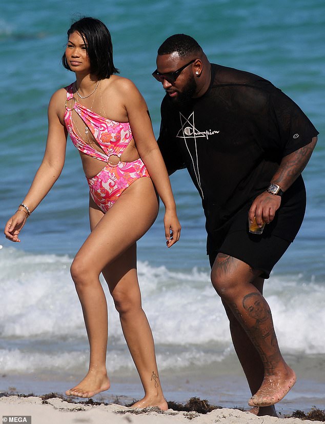 Beach day: Chanel Iman, 32, wore an elaborate pink monokini on Monday for a romantic day at the beach with her NFL boyfriend Davon Godchaux, 28, in Miami