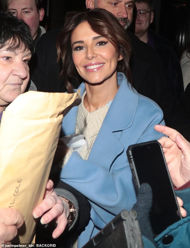 Smiles: Cheryl looked sensational as she left the Lyric Theater on Friday night in a light blue coat and white sweater.