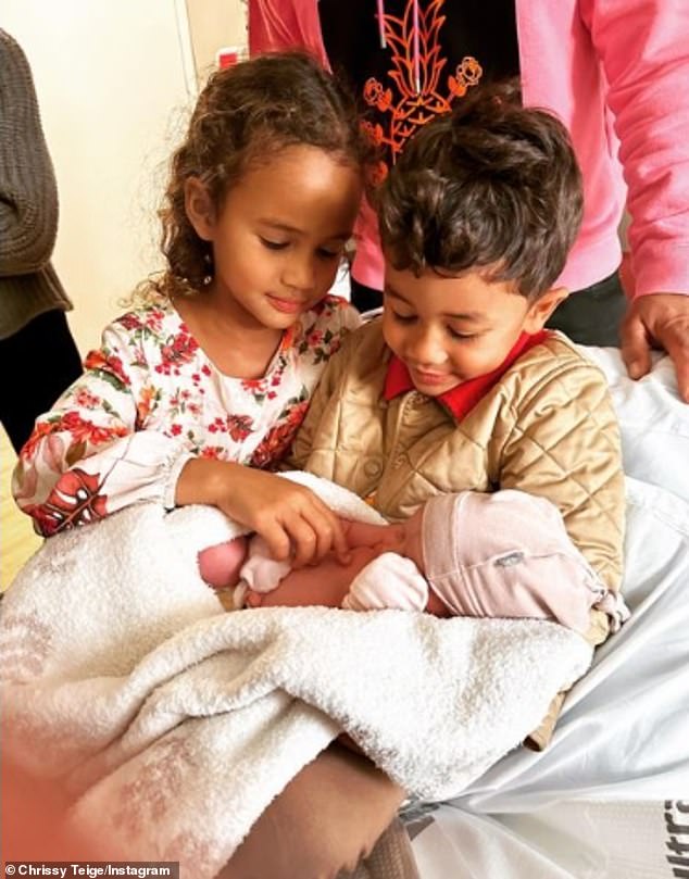 Baby joy: The proud parents originally announced their gender by sharing a sweet snap that showed the baby being held by his older siblings: daughter Luna, 6, and son Miles, 4.