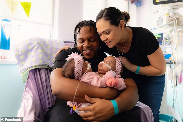 Parents Amanda Arciniega and James Finley holding the twins, who are 'recovering well' at Cook Children's Medical Center