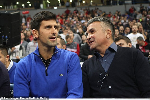 Tennis superstar Novak Djokovic (left) with father Srdjan.  After watching his son's quarterfinal win at the Australian Open, he was seen posing with a Russian flag with Vladimir Putin's face on it.