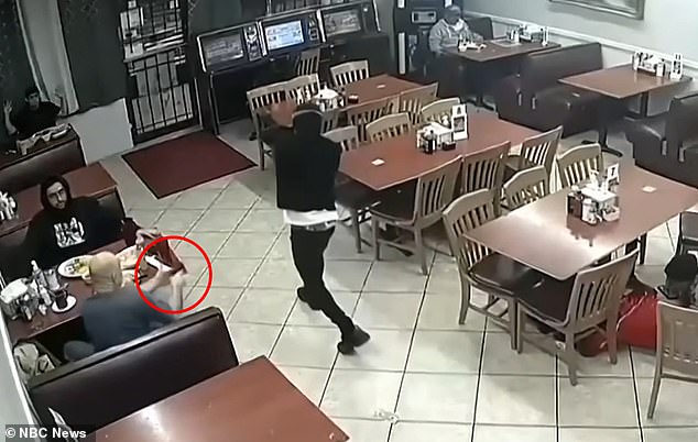 The customer shot the robber, seen in the red ring, after he entered Ranchito #4 Taqueria and demanded people's money and cell phones at gunpoint.  Police believe the masked robber was actually using a fake gun