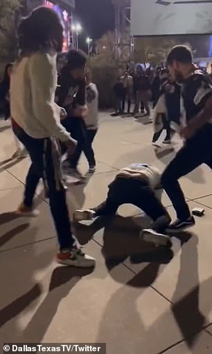 A fan wearing a white Cowboys away jersey was filmed being punched and kicked while on the ground